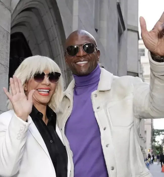 Terry Crews waves for the camera with his wife, Rebecca